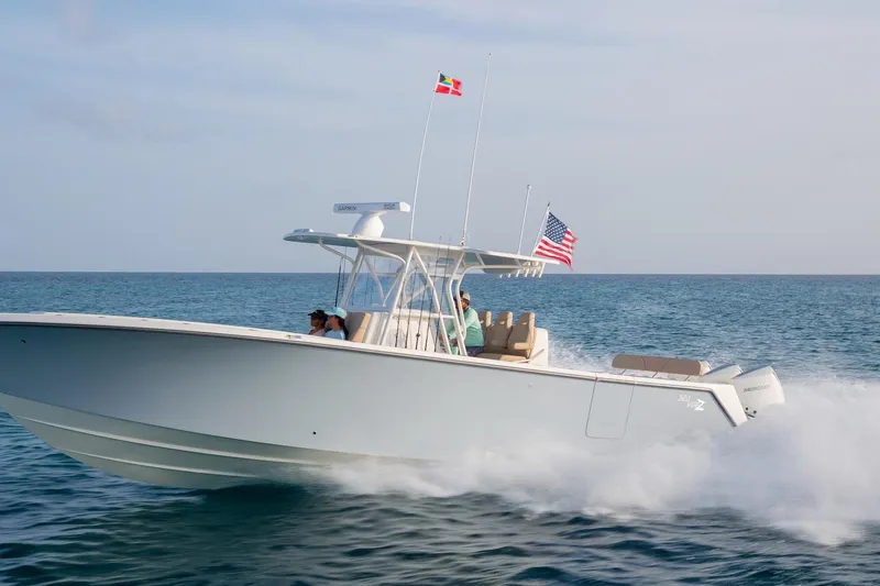 The Image of 2021 SeaVee Boats 370Z cruising on open water with flags flying. - 2