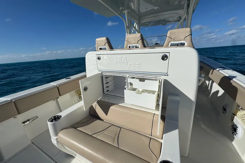 Slide: The Image of 2021 SeaVee Boats 370Z interior with seating and storage, cruising on open water. - 23