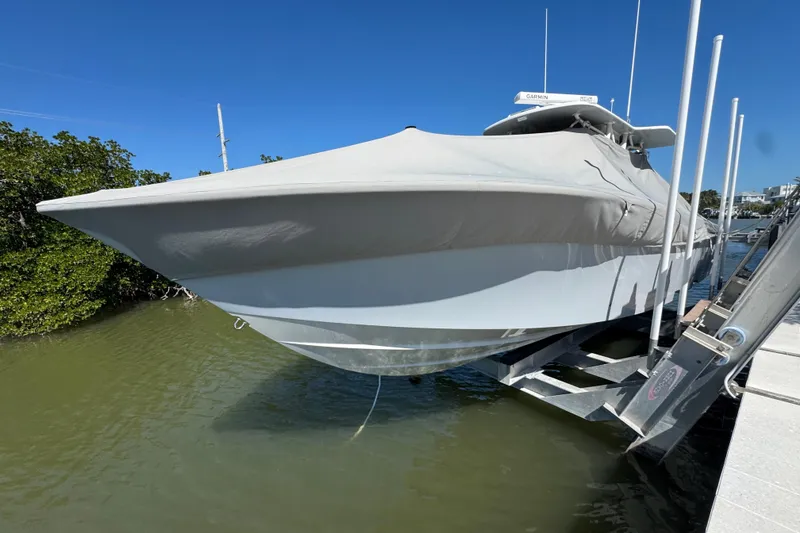 Slide: The Image of 2021 SeaVee Boats 370Z covered on a lift, docked by the water. - 4