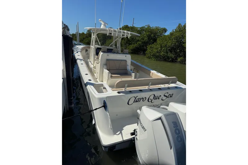 Slide: The Image of 2021 SeaVee Boats 370Z docked, featuring dual Mercury engines, in a serene waterway setting. - 7