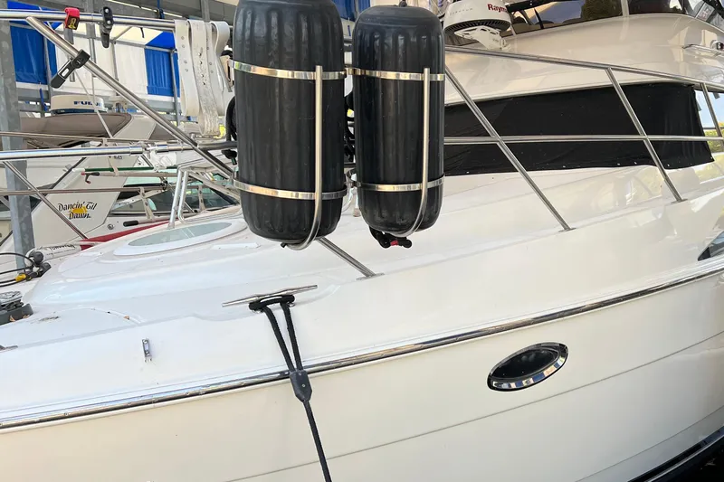 Slide: The Image of 2004 Meridian 408 Motoryacht with black fenders docked in a marina. - 2