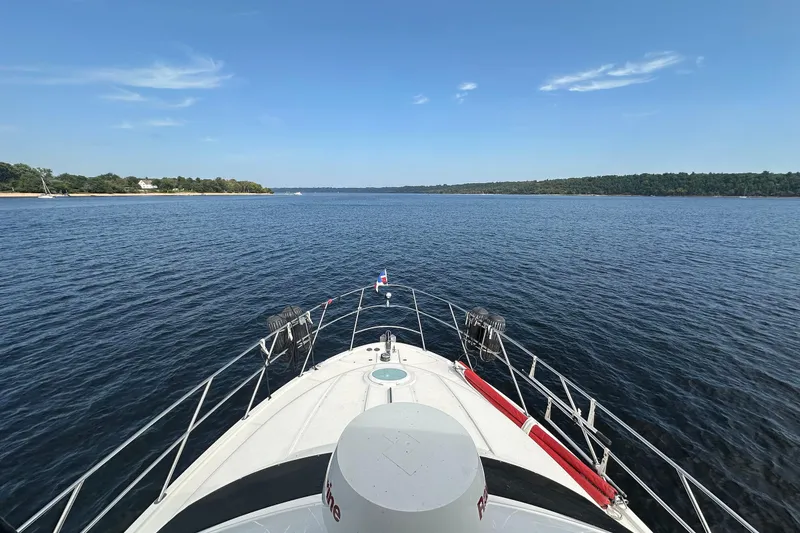 Slide: The Image of Bow view of 2004 Meridian 408 Motoryacht cruising on a calm lake. - 4