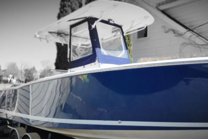 The Image of 2006 Southport 26 Center Console boat with blue hull and white canopy. - 0