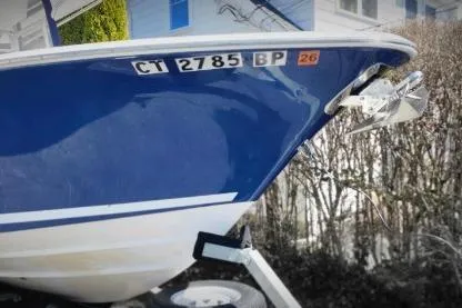 Slide: The Image of 2006 Southport 26 Center Console boat on trailer, blue hull, registration CT 2785 BP. - 1