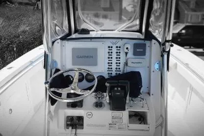 Slide: The Image of 2006 Southport 26 Center Console boat dashboard with Garmin navigation system. - 2