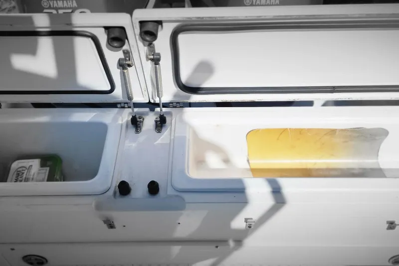 Slide: The Image of Open storage compartments on a 2006 Southport 26 Center Console boat. - 3