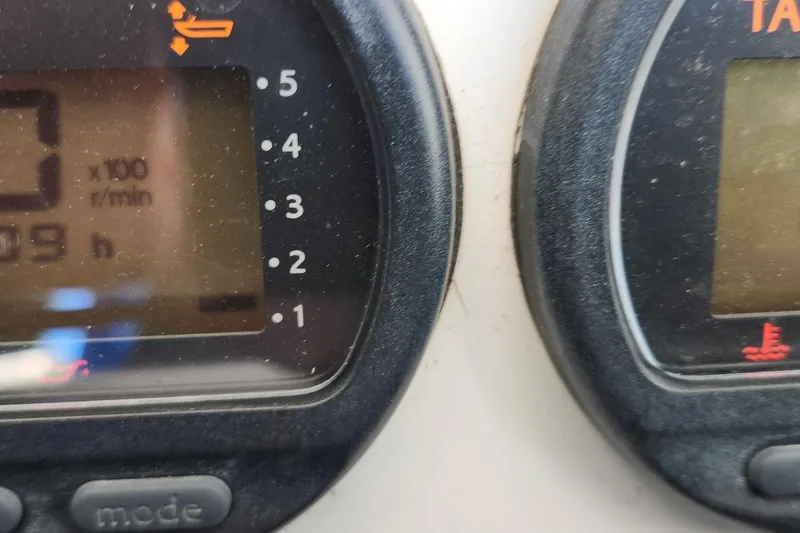 Slide: The Image of Close-up of 2006 Southport 26 Center Console boat gauges displaying RPM and hours. - 6