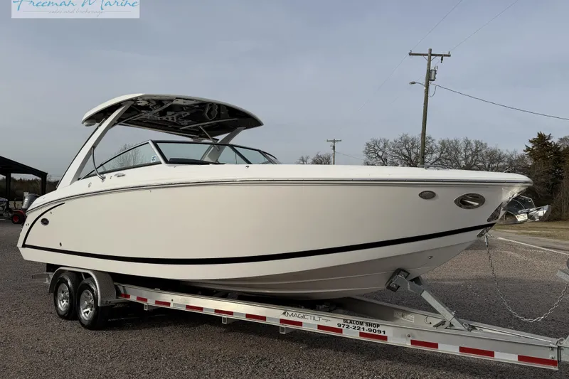 The Image of 2021 Cobalt R30 boat on trailer, sleek design, parked outdoors. - 0