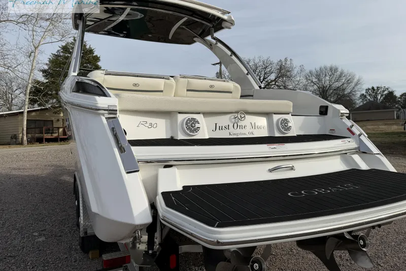 Slide: The Image of 2021 Cobalt R30 boat rear view with "Just One More" text, parked outdoors. - 12