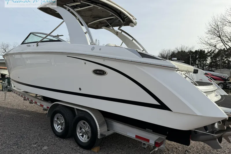 Slide: The Image of 2021 Cobalt R30 boat on trailer, sleek white design, parked outdoors. - 13