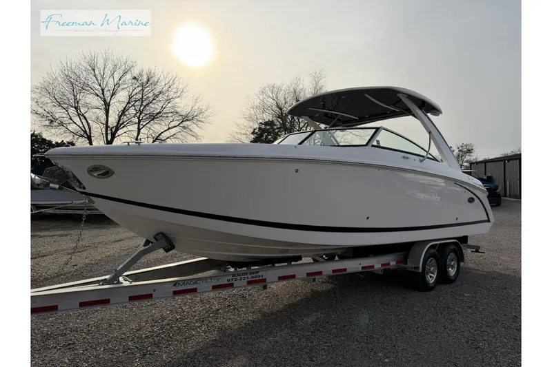 Slide: The Image of 2021 Cobalt R30 boat on trailer at Freeman Marine dealership, silhouetted against sunset. - 14