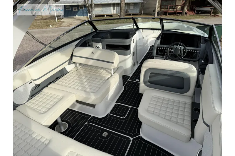 Slide: The Image of 2021 Cobalt R30 boat interior with luxurious white seating and modern dashboard. - 17
