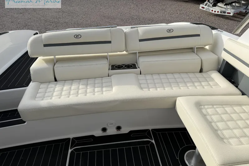 Slide: The Image of 2021 Cobalt R30 boat interior with white cushioned seating and cup holders. - 20