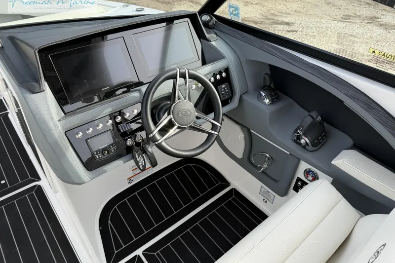Slide: The Image of 2021 Cobalt R30 boat dashboard with dual screens and steering wheel. - 21