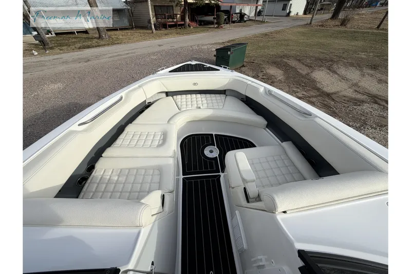 Slide: The Image of 2021 Cobalt R30 boat interior with white cushioned seating and black flooring. - 31