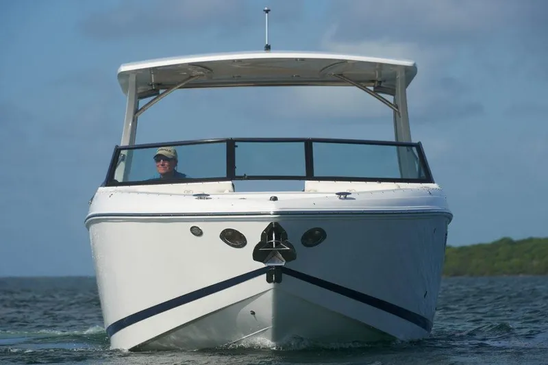 Slide: The Image of Manufacturer Provided Image: 2021 Cobalt R30 boat cruising on water, front view. - 39