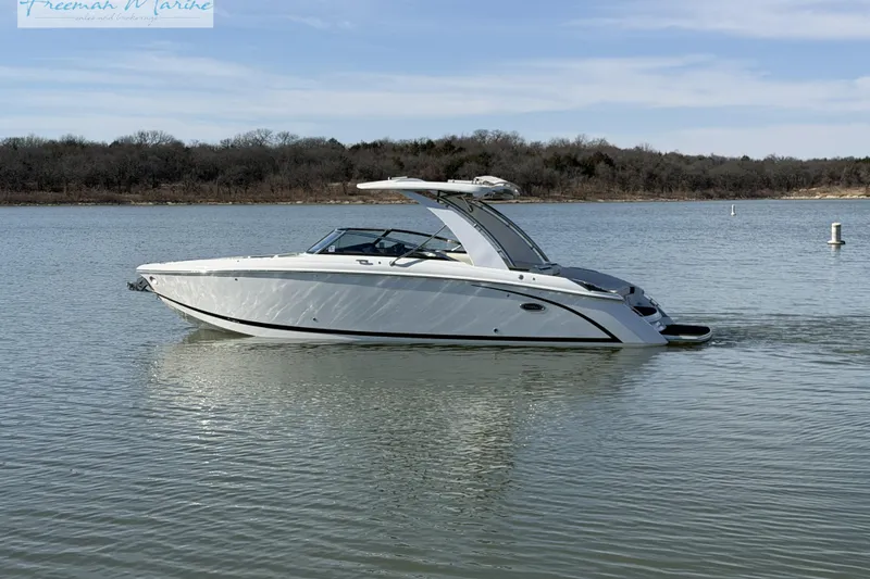 Slide: The Image of 2021 Cobalt R30 boat on calm lake with wooded shoreline. - 4