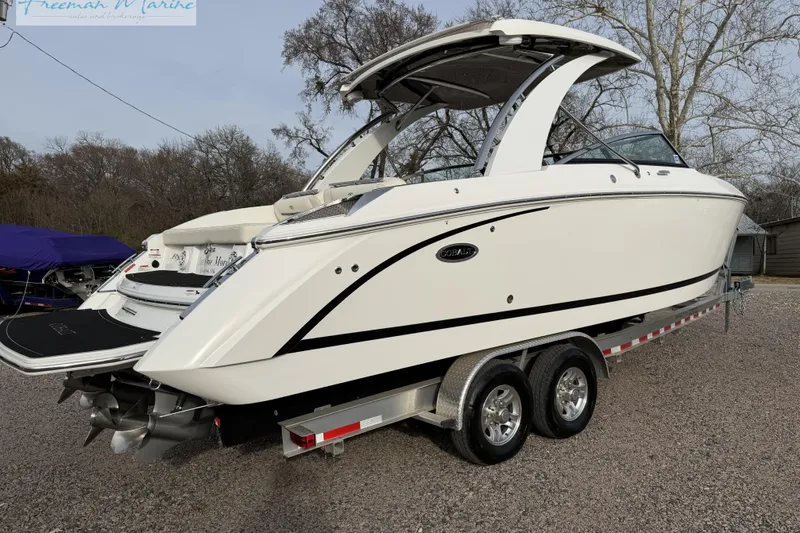 Slide: The Image of 2021 Cobalt R30 boat on trailer, sleek design, white exterior, parked outdoors. - 7