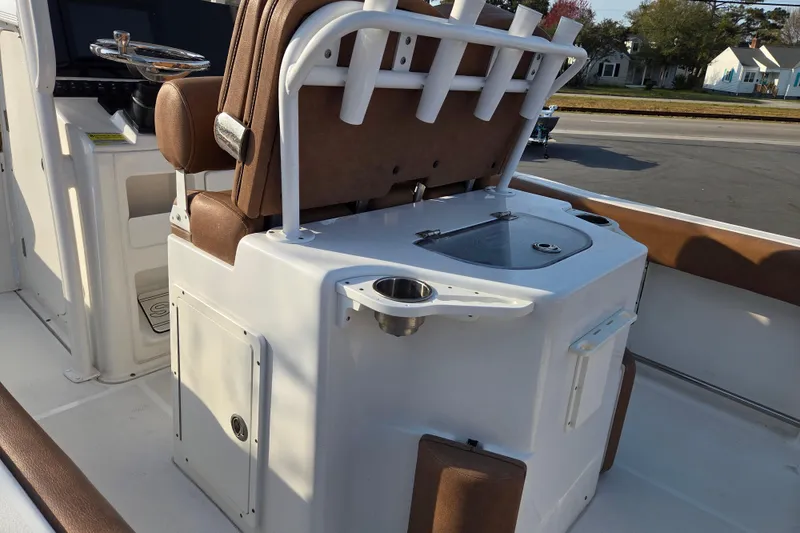 Slide: The Image of 2019 Sea Hunt Ultra 234 boat interior with seating and storage compartments. - 11