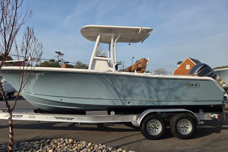Slide: The Image of 2019 Sea Hunt Ultra 234 boat on trailer, side view, outdoors. - 3