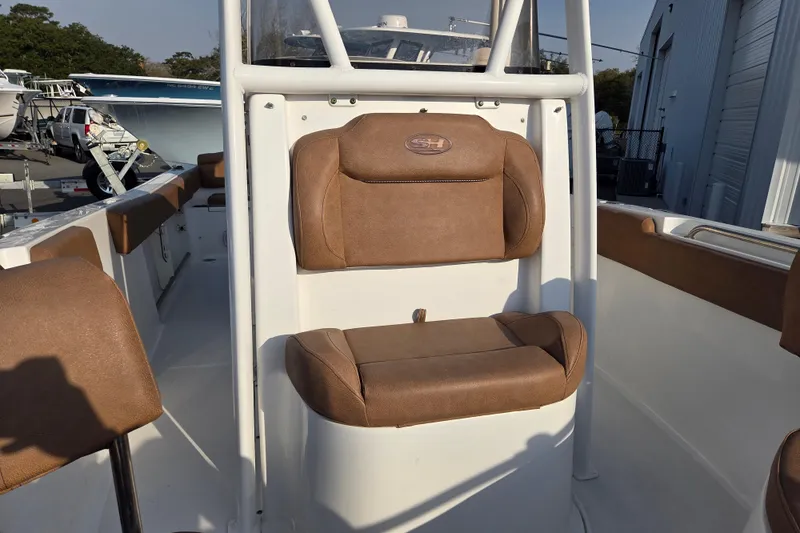 Slide: The Image of 2019 Sea Hunt Ultra 234 boat interior with brown cushioned seating. - 8