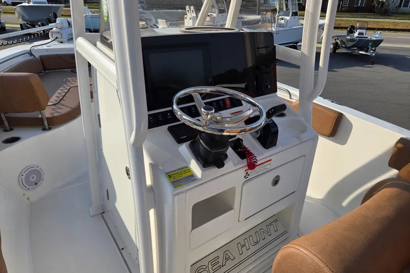 Slide: The Image of 2019 Sea Hunt Ultra 234 boat console with steering wheel and navigation display. - 9