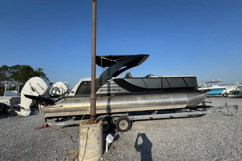 Slide: The Image of 2018 South Bay 725RS pontoon boat on trailer in a gravel lot. - 10