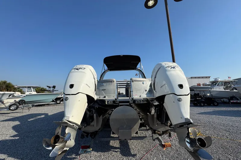 Slide: The Image of 2018 South Bay 725RS boat with dual outboard motors on display in a marina. - 13