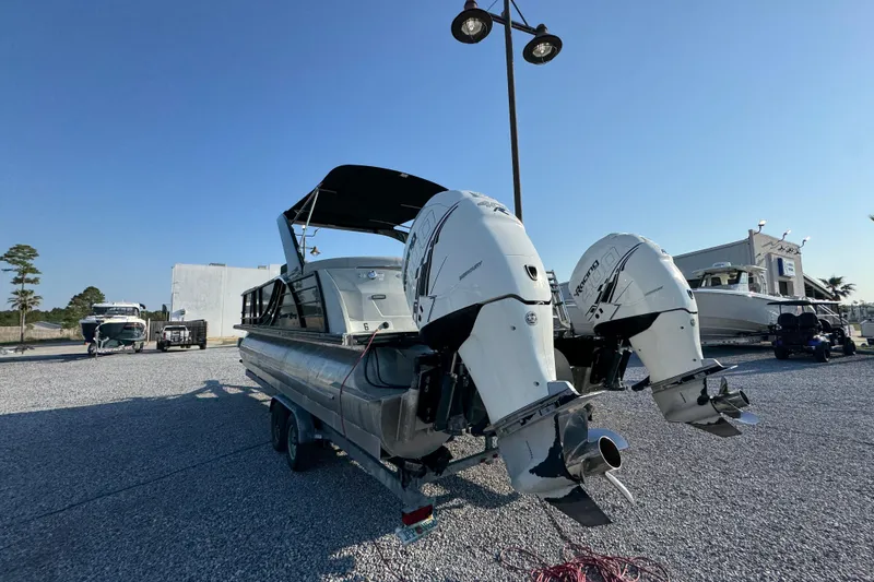 Slide: The Image of 2018 South Bay 725RS pontoon boat with dual outboard motors on a trailer. - 14