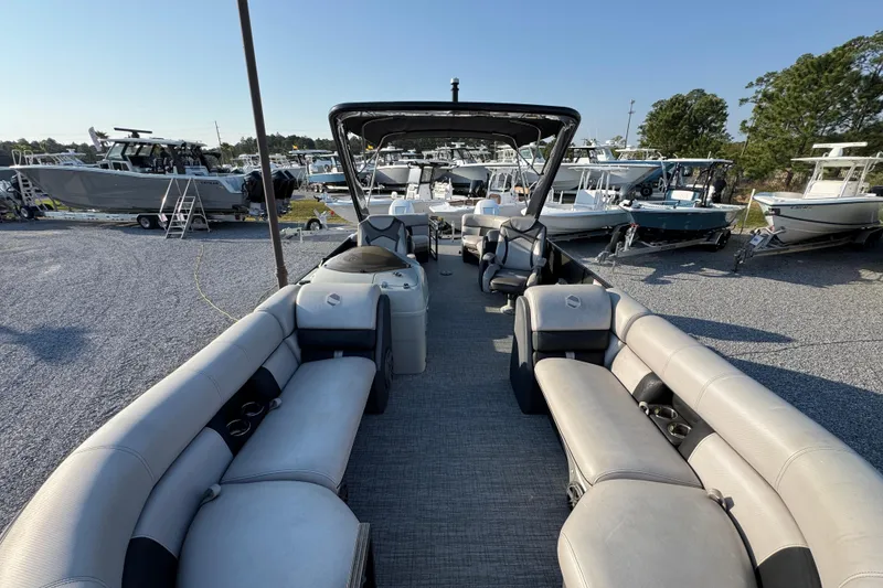 Slide: The Image of 2018 South Bay 725RS pontoon boat with spacious seating, displayed in a boatyard. - 17
