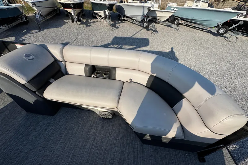 Slide: The Image of Luxurious seating on 2018 South Bay 725RS pontoon boat, surrounded by other boats. - 19