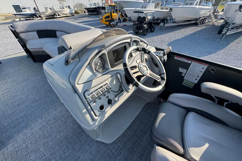 Slide: The Image of 2018 South Bay 725RS boat interior with steering wheel and seating area. - 23