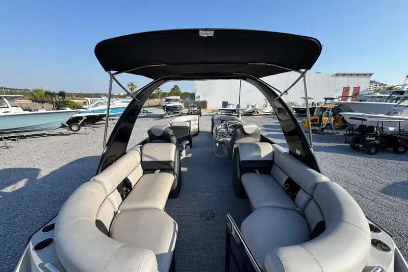 Slide: The Image of 2018 South Bay 725RS pontoon boat with spacious seating and canopy in a marina setting. - 29