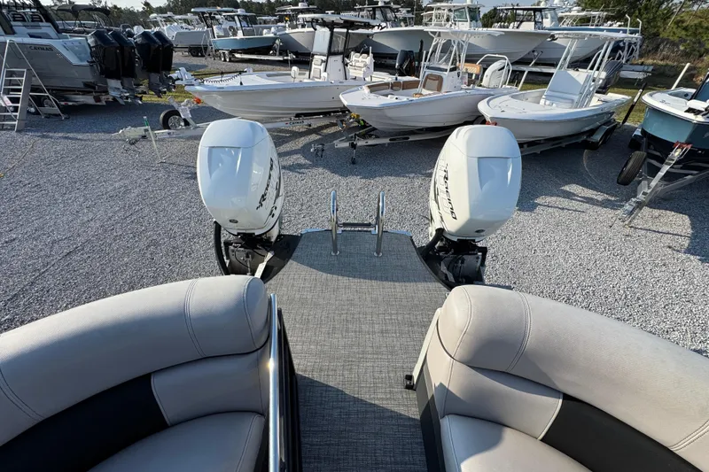 Slide: The Image of 2018 South Bay 725RS pontoon boat with twin outboard motors in a boatyard. - 30