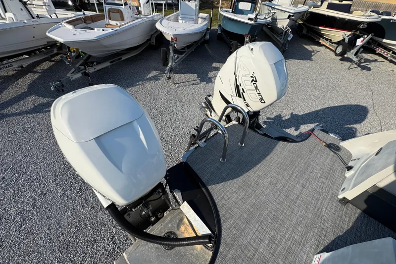 Slide: The Image of 2018 South Bay 725RS boat with dual outboard motors in a marina setting. - 32