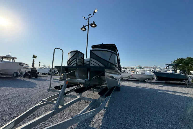 Slide: The Image of 2018 South Bay 725RS pontoon boat on trailer in sunny marina setting. - 5