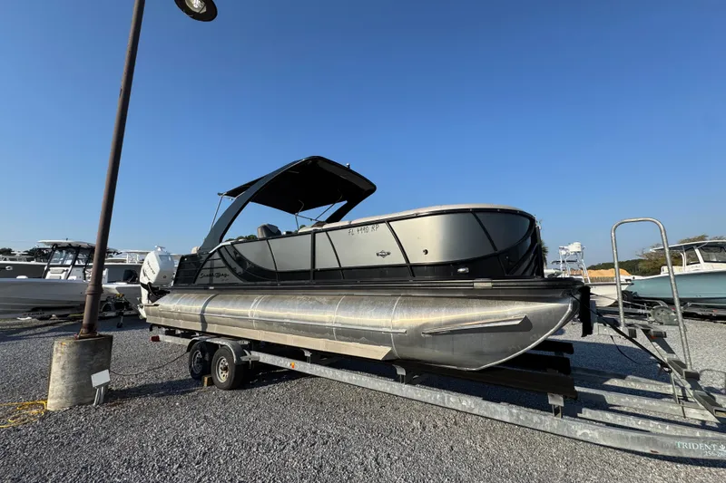Slide: The Image of 2018 South Bay 725RS pontoon boat on trailer under clear blue sky. - 8
