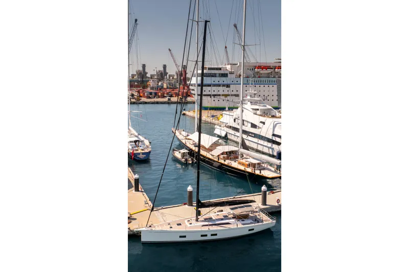 Slide: The Image of 2016 Grand Soleil 58 yacht docked in a bustling marina. - 11