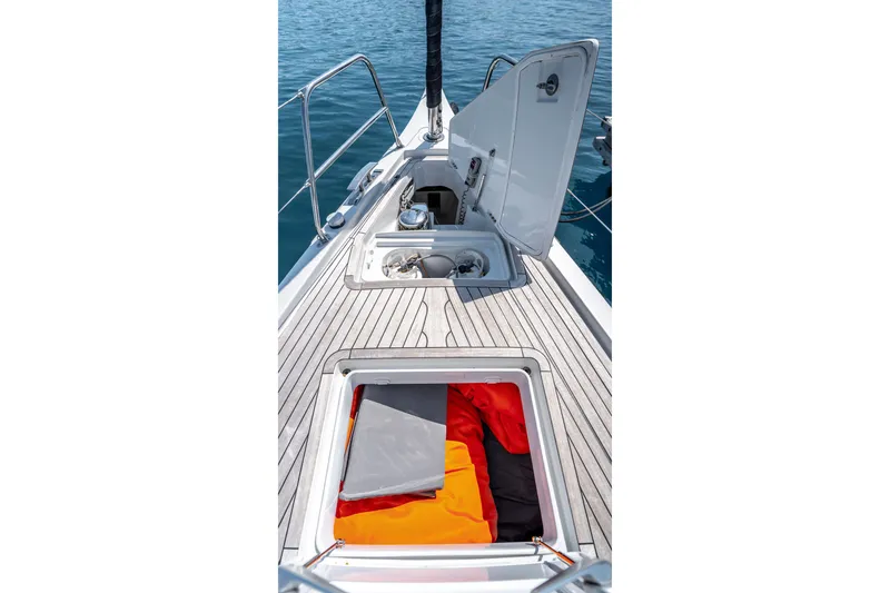 Slide: The Image of 2016 Grand Soleil 58 yacht deck with open storage compartments and vibrant gear. - 13
