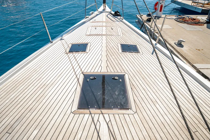 Slide: The Image of Deck of 2016 Grand Soleil 58 yacht with sleek wooden finish and ocean backdrop. - 14