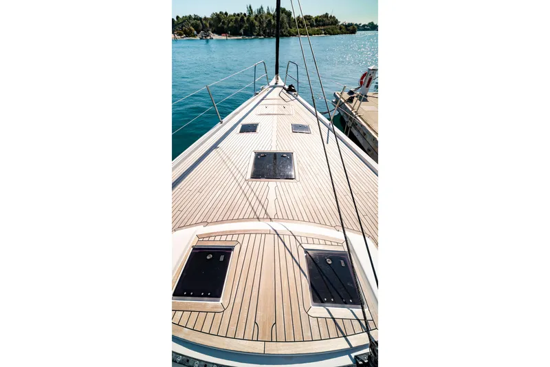 Slide: The Image of Deck view of 2016 Grand Soleil 58 yacht, docked by serene blue waters. - 16