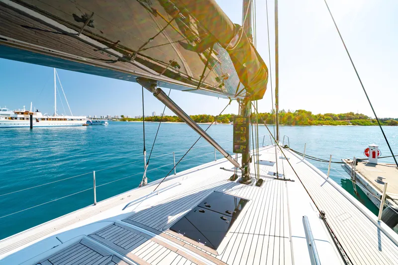 Slide: The Image of Grand Soleil 58 yacht deck, 2016 model, sailing on clear blue waters near a marina. - 18