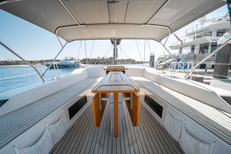 Slide: The Image of Spacious deck of 2016 Grand Soleil 58 yacht, featuring elegant wooden table and seating. - 27