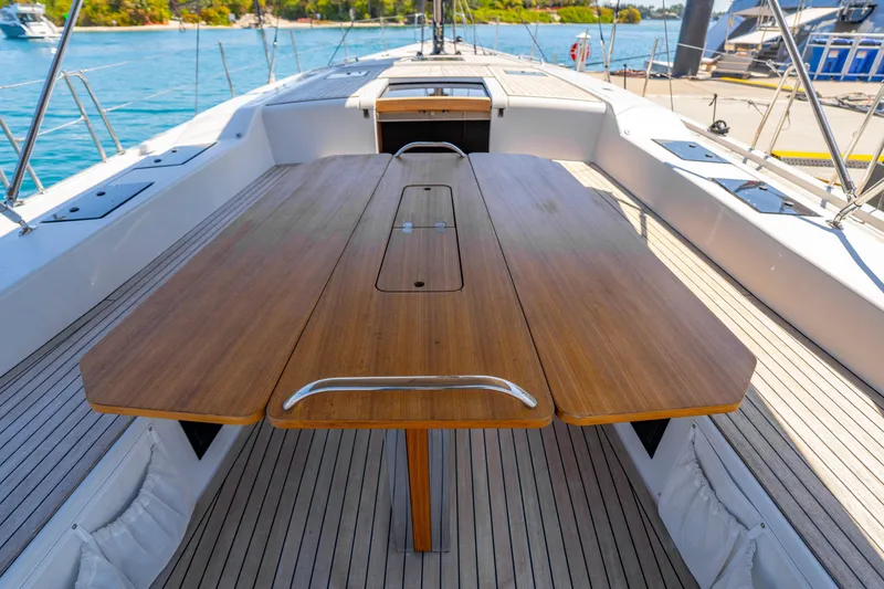 Slide: The Image of Deck view of 2016 Grand Soleil 58 yacht with wooden table and ocean backdrop. - 30