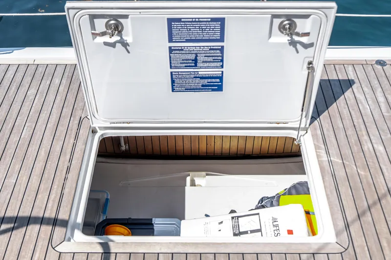 Slide: The Image of Open storage compartment on 2016 Grand Soleil 58 yacht deck, containing various items. - 34
