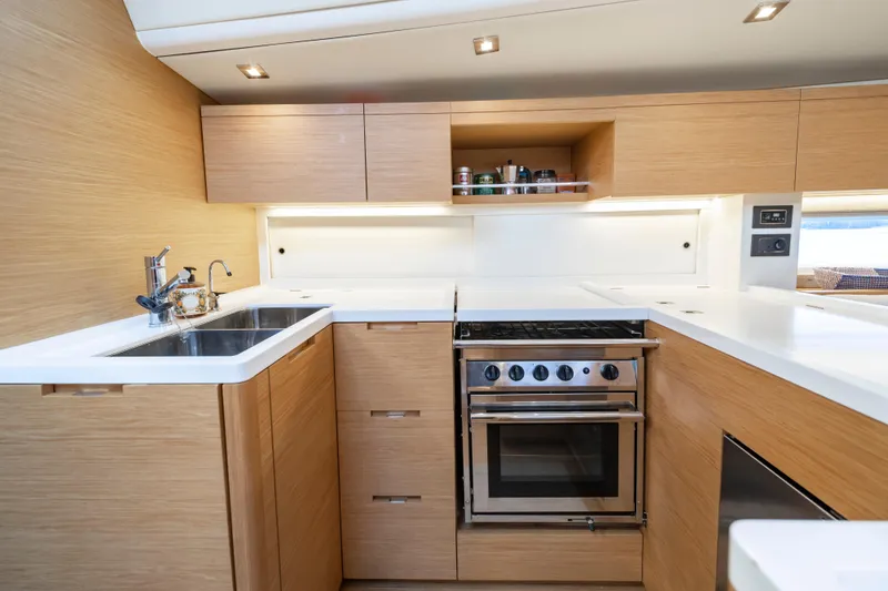 Slide: The Image of Modern kitchen interior of 2016 Grand Soleil 58 yacht with wood cabinetry and stainless steel appliances. - 41