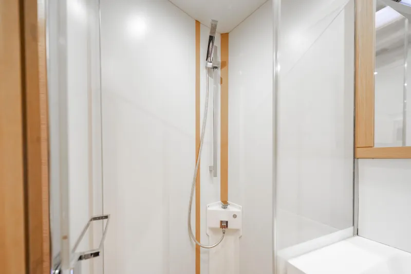 Slide: The Image of Modern shower area in 2016 Grand Soleil 58 yacht, featuring sleek design and wooden accents. - 51