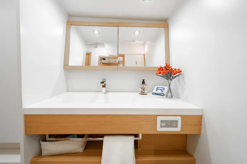 Slide: The Image of Modern bathroom vanity on 2016 Grand Soleil 58 yacht, featuring mirror and floral decor. - 53