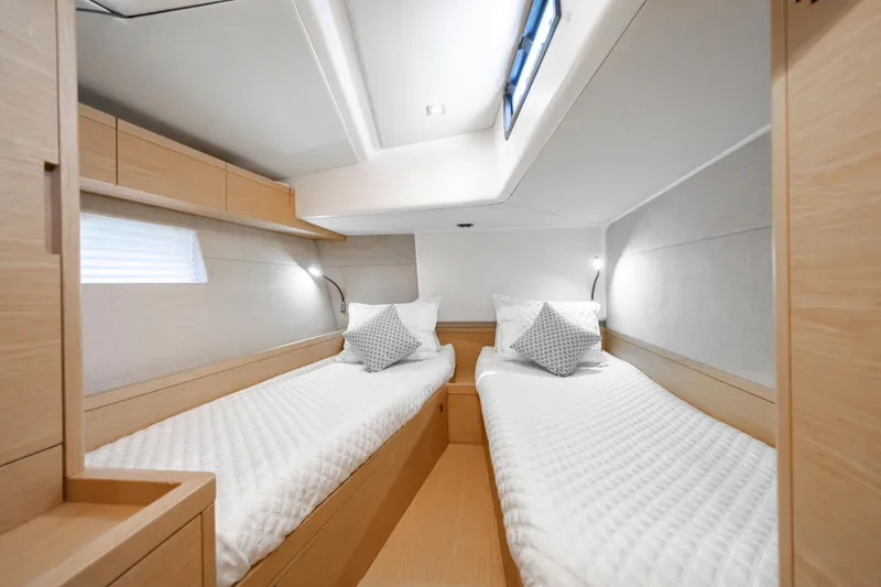 Slide: The Image of Luxurious twin cabin interior of 2016 Grand Soleil 58 yacht, featuring modern design and cozy bedding. - 57