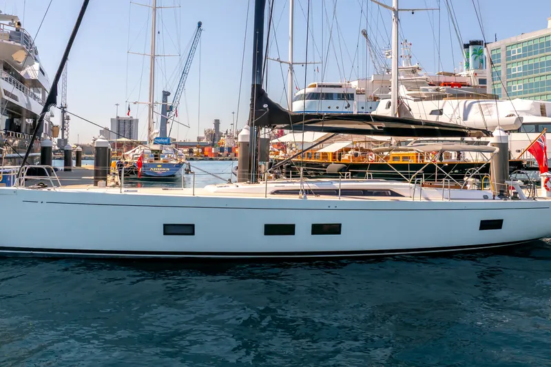 Slide: The Image of 2016 Grand Soleil 58 yacht docked in a busy marina, surrounded by other boats. - 6